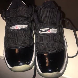 Kids black Jordan’s low 11’s